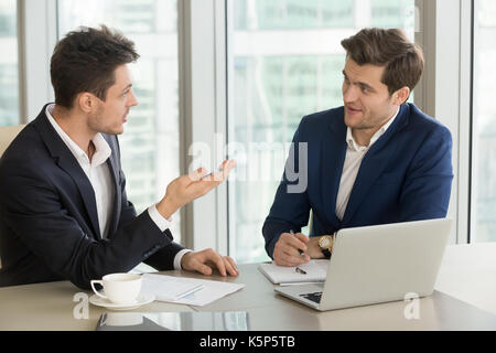 Young businessman convincing experienced colleague Stock Photo
