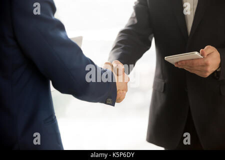 Close up photo of IT businessmen shaking hands Stock Photo