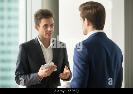 Colleagues discussing possible solution or ideas Stock Photo