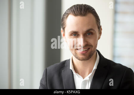 Close up portrait of young handsome successful smiling businessm Stock Photo