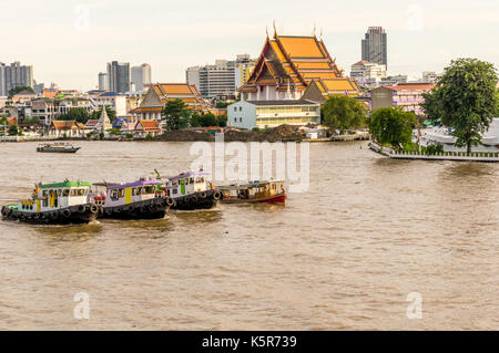 tug boats on the Chao Praya river in Bangkok Thailand Stock Photo