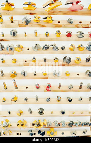 High angle view of wooden shelves with different types of drill bits and spare parts for woodworking tools Stock Photo
