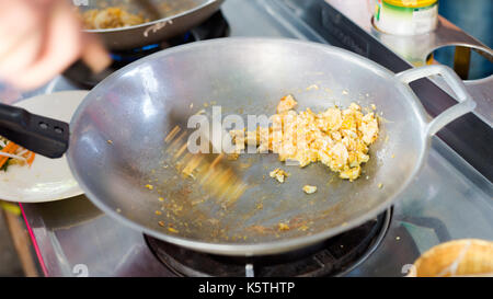 Preparing Pad thai in wok frying pan. Picture of traditional thai cuisine made of fresh ingredients taken during cooking class in Chiang Mai. Stock Photo