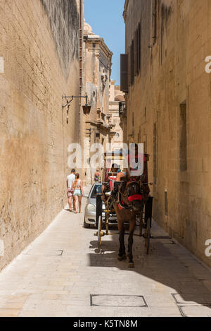 MDINA, MALTA - AUGUST 21, 2017: Tourists visiting the beautiful Silent city of Mdina.  Mdina is one of Game of Thrones movie HBO filming locations in  Stock Photo