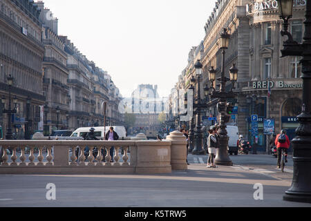 A street view of the Avenue de l'Opéra with Banque Solfea on the right and Hôtel du Louvre (Hyatt) in the background. Paris, France Stock Photo