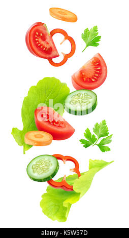 Isolated vegetables mix. Pieces of fresh tomato, cucumber, carrot, bell pepper and lettuce leaves (salad ingredients) in the air isolated on white bac Stock Photo
