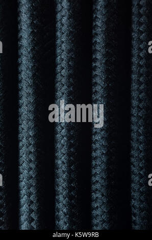 Wires in Black Textile Braid Background. Texture of Black Cables Stock Photo