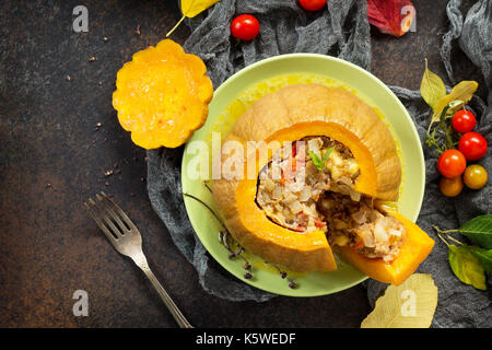 Baked pumpkin stuffed with Turkey, tomatoes, onions and cheese. The concept of food on thanksgiving. Stock Photo