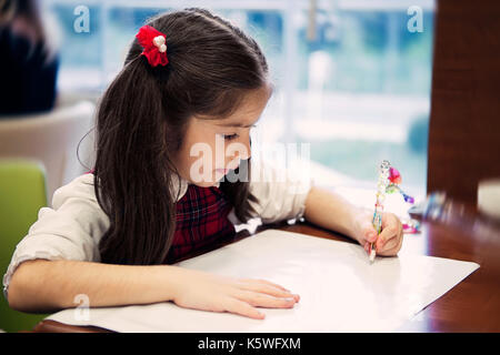 Little girl making homework Stock Photo