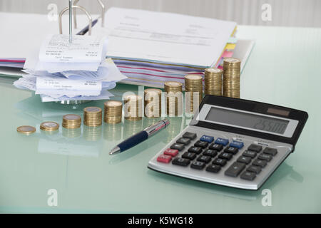 Receipts In Paper Nail With Calculator And Money On Desk Stock Photo