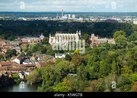 Historic view from an elevated position of Eton Chapel ( in the centre of the frame ) and Eton College. Slough trading estate is in the distance. UK. The camera is positioned in Windsor so the trees in the foreground are Windsor trees Stock Photo