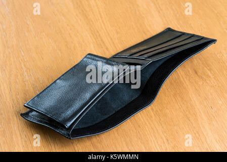 Empty leather wallet laying open on a table. Bankruptcy, unemployed, finance. Stock Photo