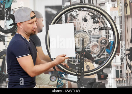Repair technician bicycles was repaired gear bike shop. Stock Photo
