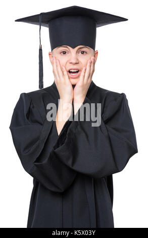 Portrait of sad or surprised graduate teen boy student in mantle with black hat, isolated on white background Stock Photo