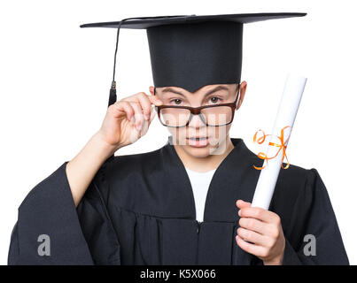 Portrait of sad or surprised graduate teen boy student in mantle with black hat and eyeglasses, holding diploma - isolated on white background. Child  Stock Photo