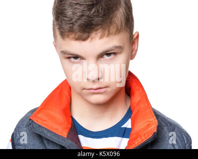 Teen boy making silly grimace - expressing disgust face. Upset child isolated on white background. Emotional portrait of caucasian teenager looking at Stock Photo