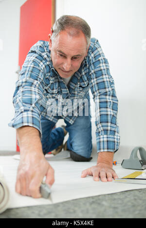 young man fitting linoleum Stock Photo