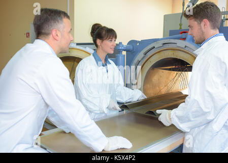 group of scientists industrial oven Stock Photo
