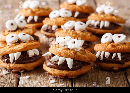 monsters from a nut cookie with chocolate filling close-up on a table. horizontal Stock Photo