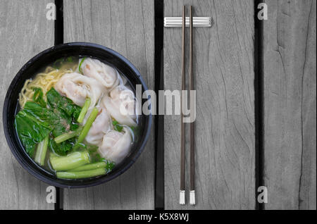 Wonton noodle soup on wooden table Stock Photo