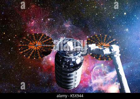 The Cygnus spacecraft in open space. Elements of this image furnished by NASA. Stock Photo