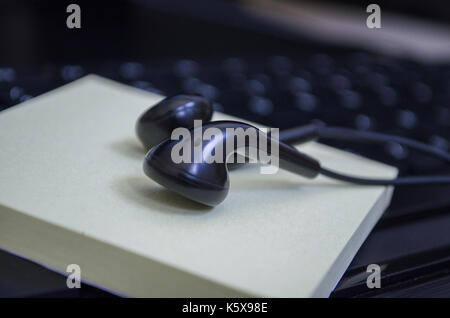 headphone over laptop keybaord Stock Photo