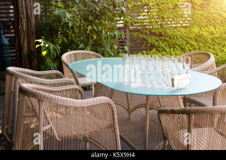 Wicker armchairs and table, modern garden furniture. Cozy space for relax in the garden. Stock Photo