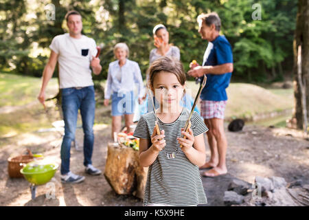 Beautiful family camping in forest, eating together. Stock Photo