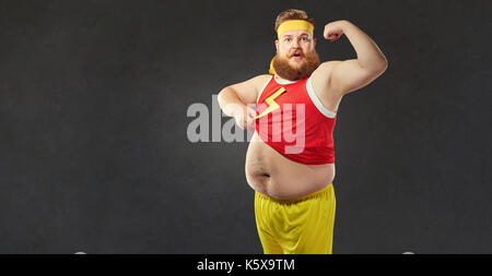 A funny fat man with a big belly shows the muscles on his arm.  Stock Photo