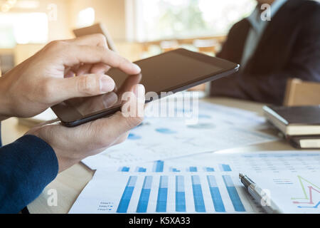 Team job succes. Closeup photo young hands business managers holding tablet working with new startup project in office.Analyze document plan. Stock Photo