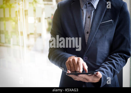Image Close-up, Young businessmen working with tablet during explanation of new plan project data at office. Stock Photo