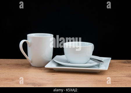 White crockery in front of a black background Stock Photo