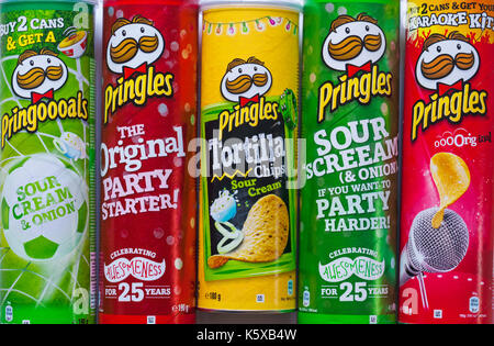 Tubs of different varieties of Pringles original, sour cream & onion and Tortilla chips sour cream with different packaging and offers Stock Photo