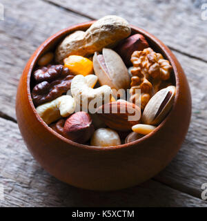 Mixed nuts in wooden bowl Stock Photo