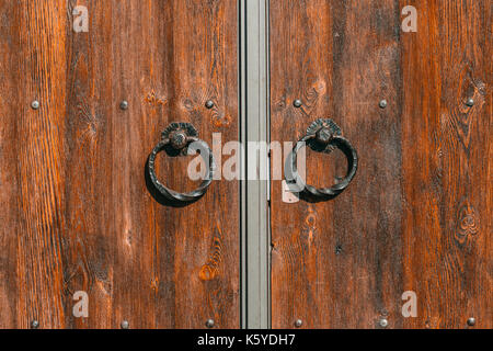 Wooden door with iron handles. Stock Photo