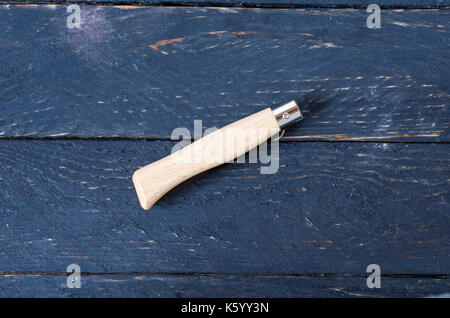 Knife in a folded form on a black background. Black background. Stock Photo