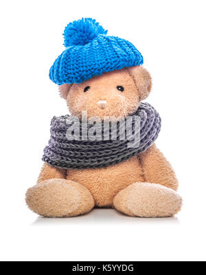 Teddy bear in hat and scarf on a white background. Stock Photo