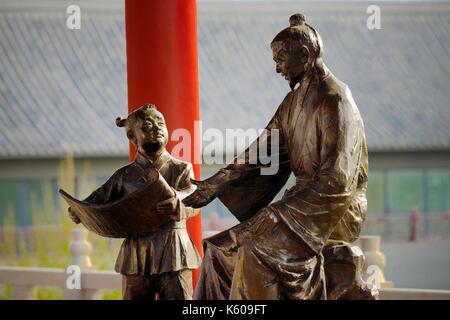 Dongzi Culture Park, Dezhou, China. Statue of Confucian philosopher Dong Zhongshu teaching boy on the rebuilt Reading Platform Stock Photo
