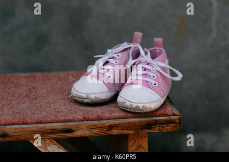 Old baby sneakers closeup photo. Stock Photo