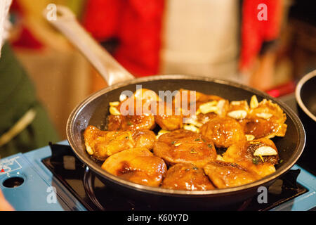 Cooking mushrooms in a pan Stock Photo