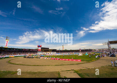 Ulaanbaatar, Mongolia - June 11, 2007: Clear blue sky hovering over the crowded stadium field at the opening ceremony of the Naadam Festival Stock Photo