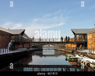 Visitors crossing bridge linking 2 warehouses at Hakodate's Kanemori Red Brick Warehouse area, Hokkaido, Japan Stock Photo