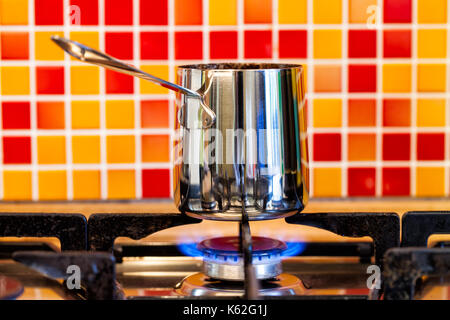 Heating up espresso coffee in a Cuban coffee maker using a mini gas stove  with a Coleman propane tank on a single burner. A thunderstorm is  approaching Stock Photo - Alamy