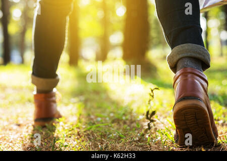 foot of young Man Traveler with backpack relaxing outdoor with handle map on background Summer vacations and Lifestyle hiking concept. Stock Photo