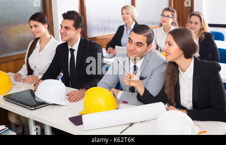 Multinational professional students and coach at design training session for employees Stock Photo