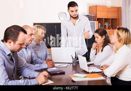 Crisis hits the company: upset adult  business team in office Stock Photo