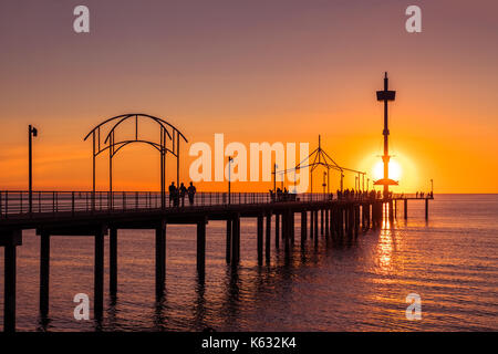 Brighton Beach jetty with people at sunset, South Australia Stock Photo