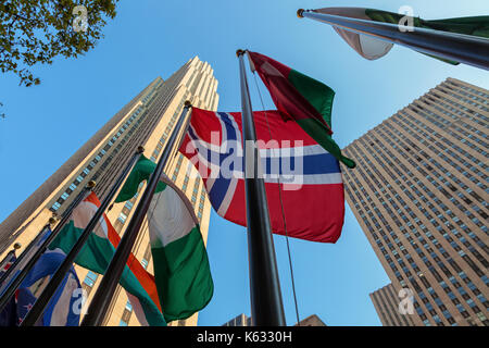 Flags of  the world nations fly at the Rockefeller Center with the Rockefeller Building in the background, New York City, New York Stock Photo