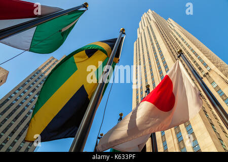 Flags of the world nations fly at the Rockefeller Center with the Rockefeller Building in the background, New York City, New York Stock Photo