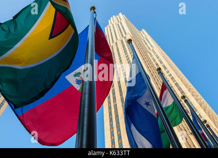 Flags of the world nations fly at the Rockefeller Center with the Rockefeller Building in the background, New York City, New York Stock Photo